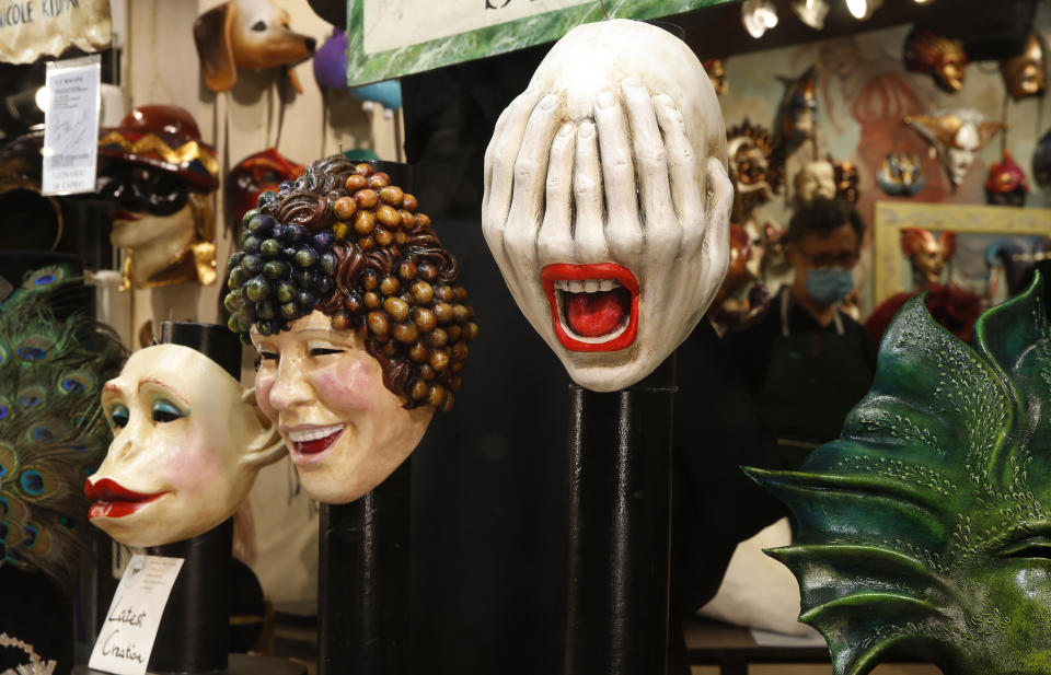 Carnival masks on display in a shop window in Venice, Italy, Saturday, Jan. 30, 2021. In another year, masks would be an accepted sign of gaiety in Venice, an accessory worn for games, parties and crowds. Since the onset of the COVID-19 pandemic face masks are worn now to protect, not amuse. (AP Photo/Antonio Calanni)