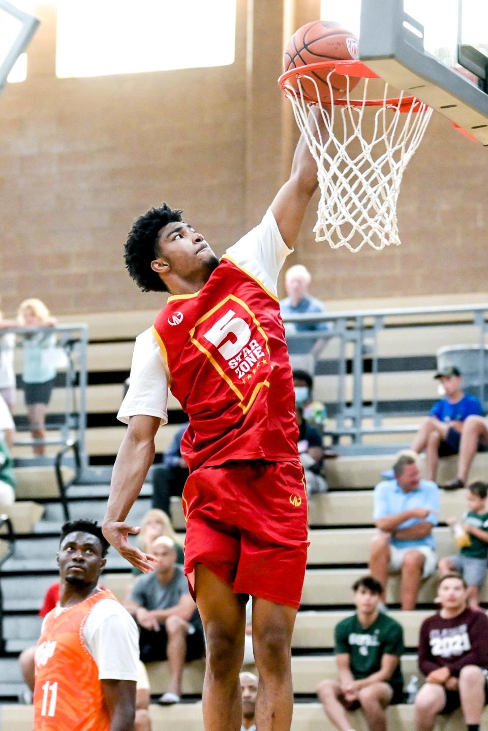 Team 5 Star Zone and MSU's Jaden Akins dunks on Thursday, June 30, 2022, in the game against Team Faygo during the Moneyball Pro-Am at Holt High School.