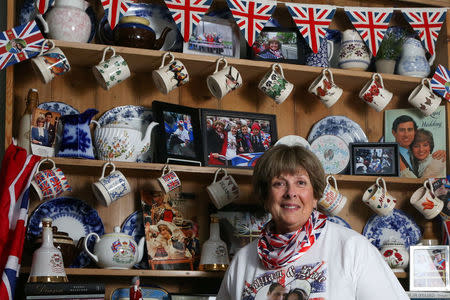 FILE PHOTO: Royal superfan Donna Werner poses with some of the photos and memorabilia she has collected traveling to England for the weddings of Prince Andrew, Prince William and Queen Elizabeth's 90th birthday celebration, at her home in New Fairfield, Connecticut, U.S. March 20, 2018. REUTERS/Michelle McLoughlin