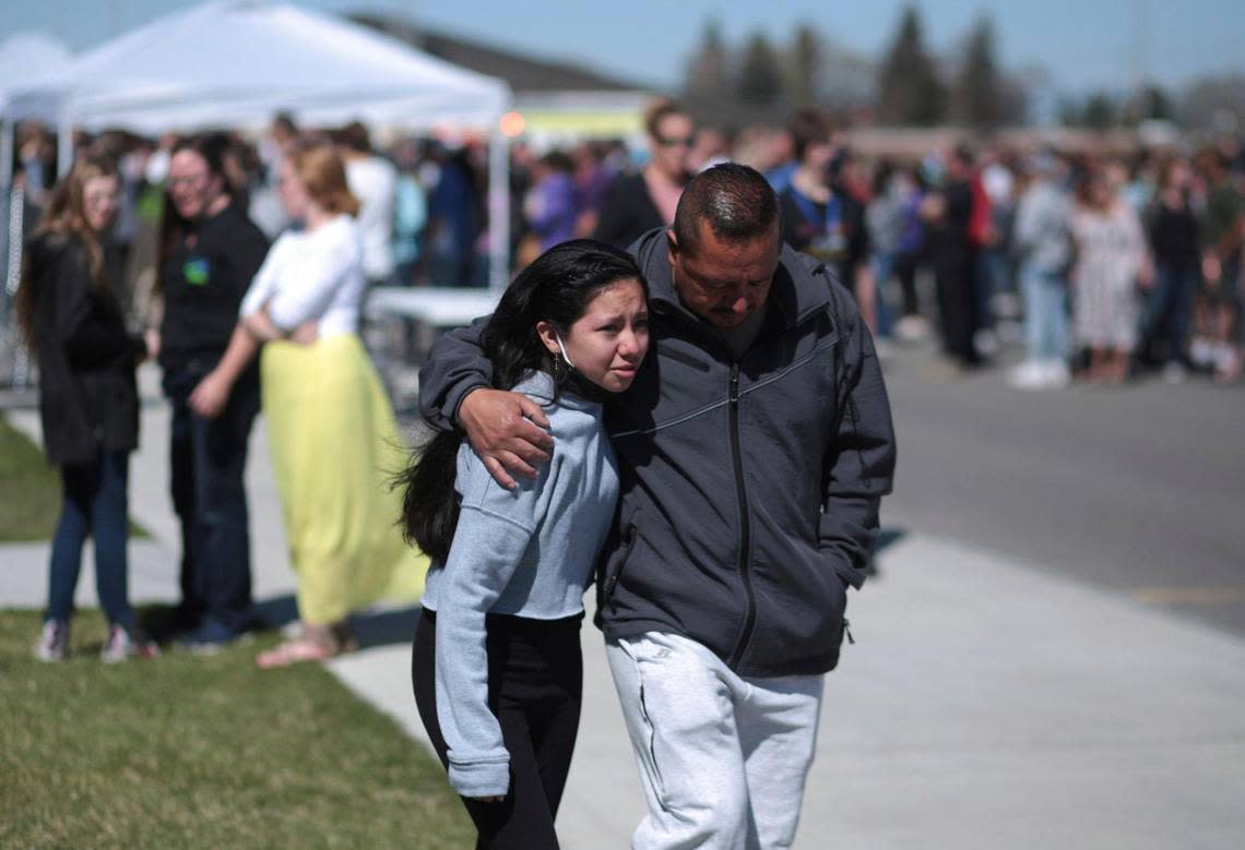 People embrace after a school shooting at Rigby Middle School on Thursday, May 6, 2021.