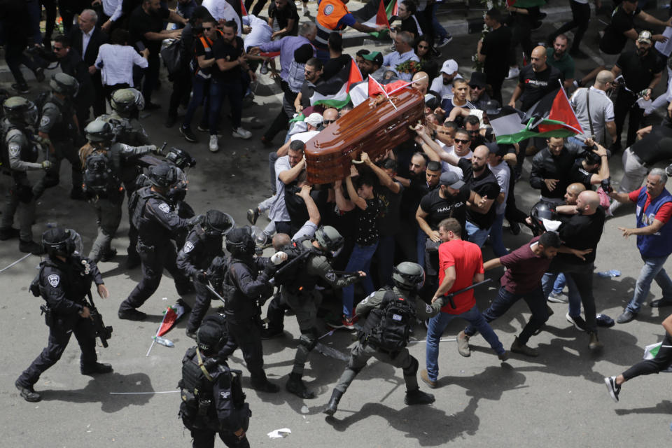 FILE - Israeli police clash with mourners as they carry the coffin of slain Al Jazeera journalist Shireen Abu Akleh during her funeral in east Jerusalem, on May 13, 2022. Abu Akleh, a Palestinian-American reporter who covered the Mideast conflict for more than 25 years, was fatally shot two days earlier during an Israeli military raid in the West Bank town of Jenin. (AP Photo/Maya Levin, File)
