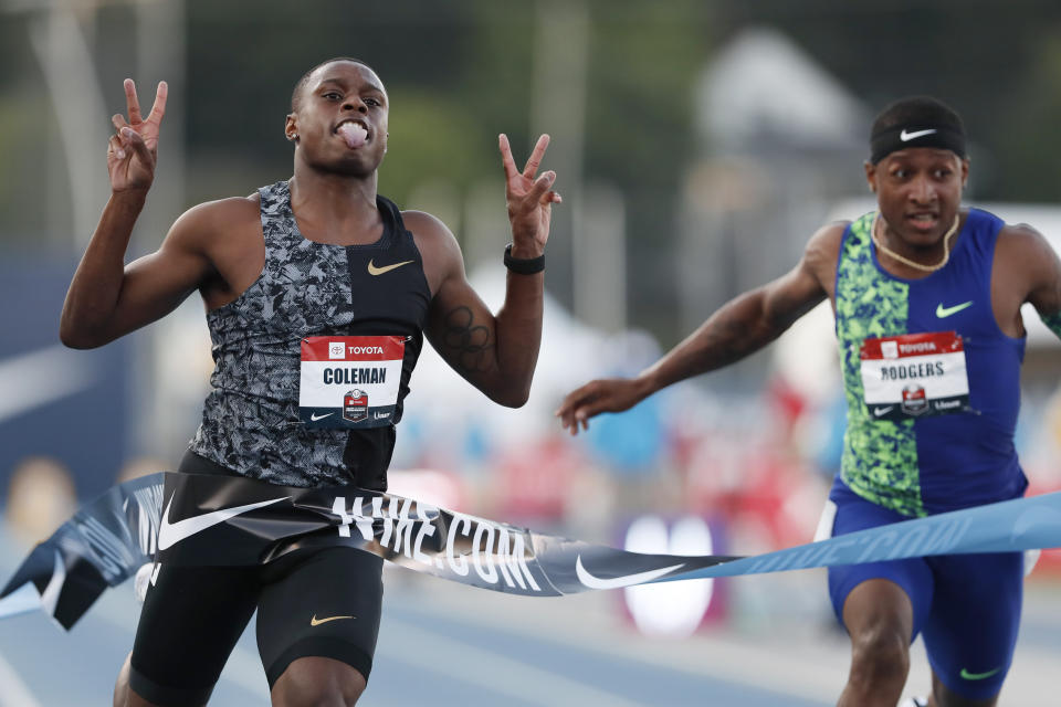 Christian Coleman celebrates in front of Michael Rodgers, right, as he wins the men's 100-meter dash final at the U.S. Championships athletics meet, Friday, July 26, 2019, in Des Moines, Iowa. (AP Photo/Charlie Neibergall)