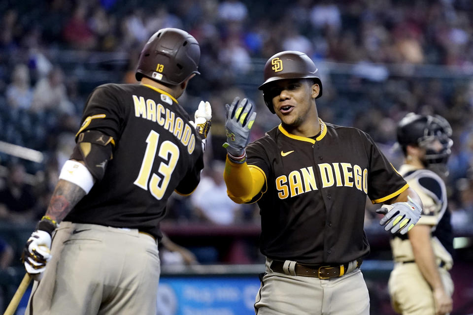 San Diego Padres' Juan Soto, right, celebrates his home run against the Arizona Diamondbacks with Padres' Manny Machado (13) during the fifth inning of a baseball game in Phoenix, Sunday, Sept. 18, 2022. (AP Photo/Ross D. Franklin)