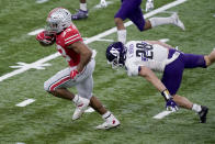 Ohio State running back Master Teague III, left, runs with the ball past Northwestern linebacker Chris Bergin (28) during the first half of the Big Ten championship NCAA college football game, Saturday, Dec. 19, 2020, in Indianapolis. (AP Photo/Darron Cummings)