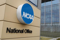 FILE - Signage at the headquarters of the NCAA is viewed in Indianapolis, March 12, 2020. NCAA member schools voted to ratify a new, pared-down constitution Thursday, Jan. 20, 2022, paving the way for a decentralized approach to governing college sports that will hand more power to schools and conferences. (AP Photo/Michael Conroy, File)