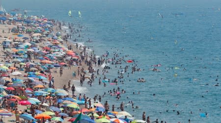 People cool-off in the Mediterranean sea in Calella