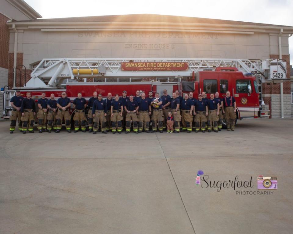 Brett Korves' colleagues at the firehouse with his daughter, Brett Grace Korves | Samantha Kallal/ Sugarfoor Photography