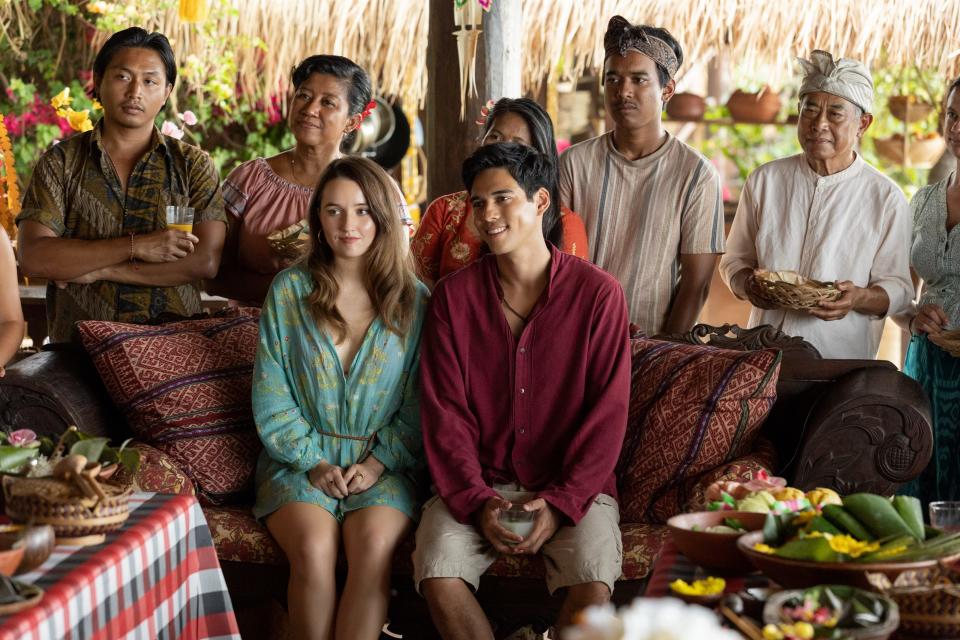 Lily (Kaitlyn Dever) and Gede (Maxime Bouttier) ready for their wedding alongside his extended family in "Ticket to Paradise."