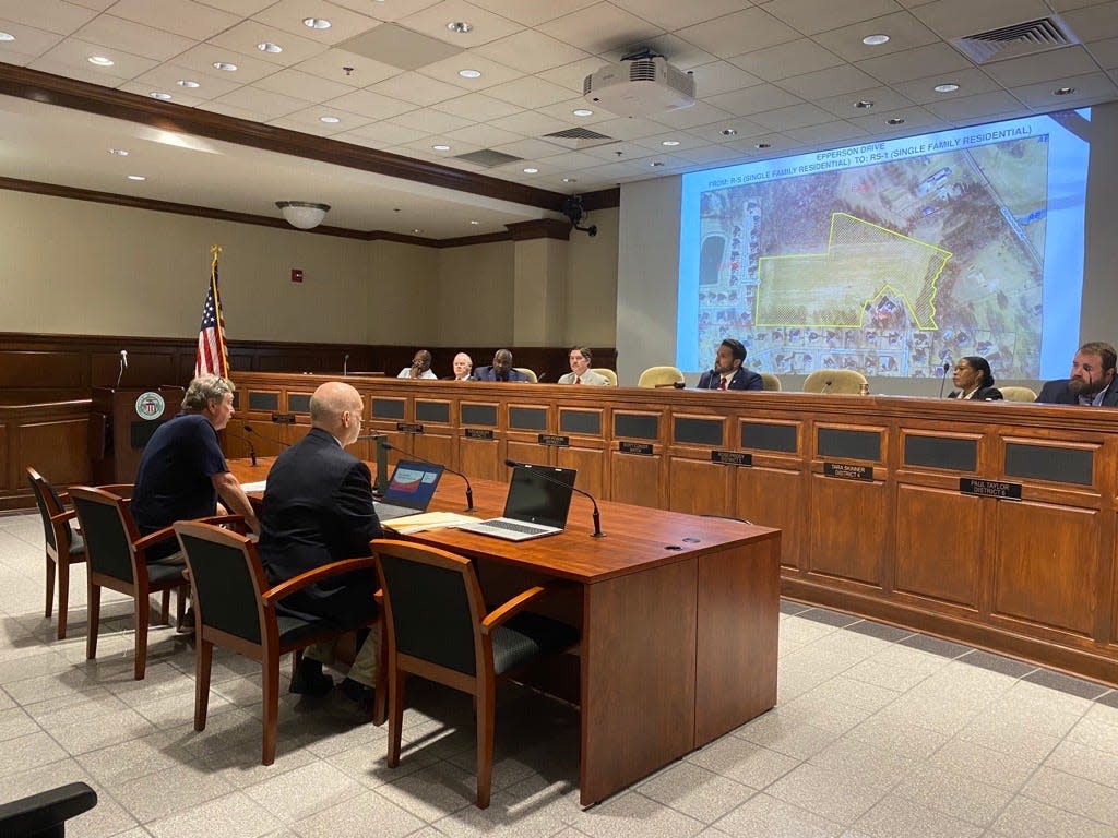 Lee Godfrey, a real estate agent involved in the development, speaks with the city council about the possibility of adding an access road.