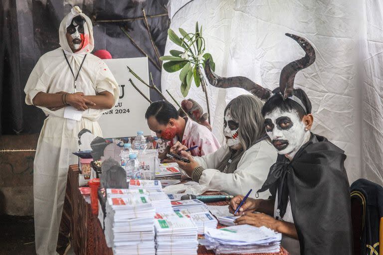 Fiscales de mesa vestidos con disfraces de temática de horror en un centro de votación durante las elecciones presidenciales y legislativas de Indonesia en Surabaya el 14 de febrero de 2024.