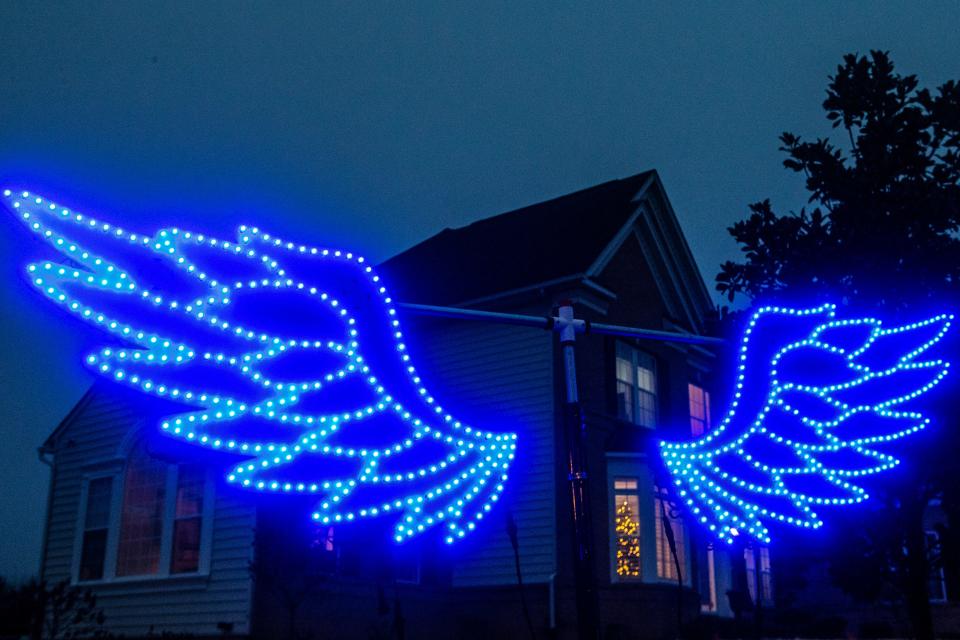 Light up wings make up the "photo booth" of the 31,000 Christmas lights display Manny Duarte mounts each year outside his home in Middletown, Wednesday, Dec. 7, 2022. The interactive "photo booth" allows visitors to change the wing colors via remote control before taking their pictures.