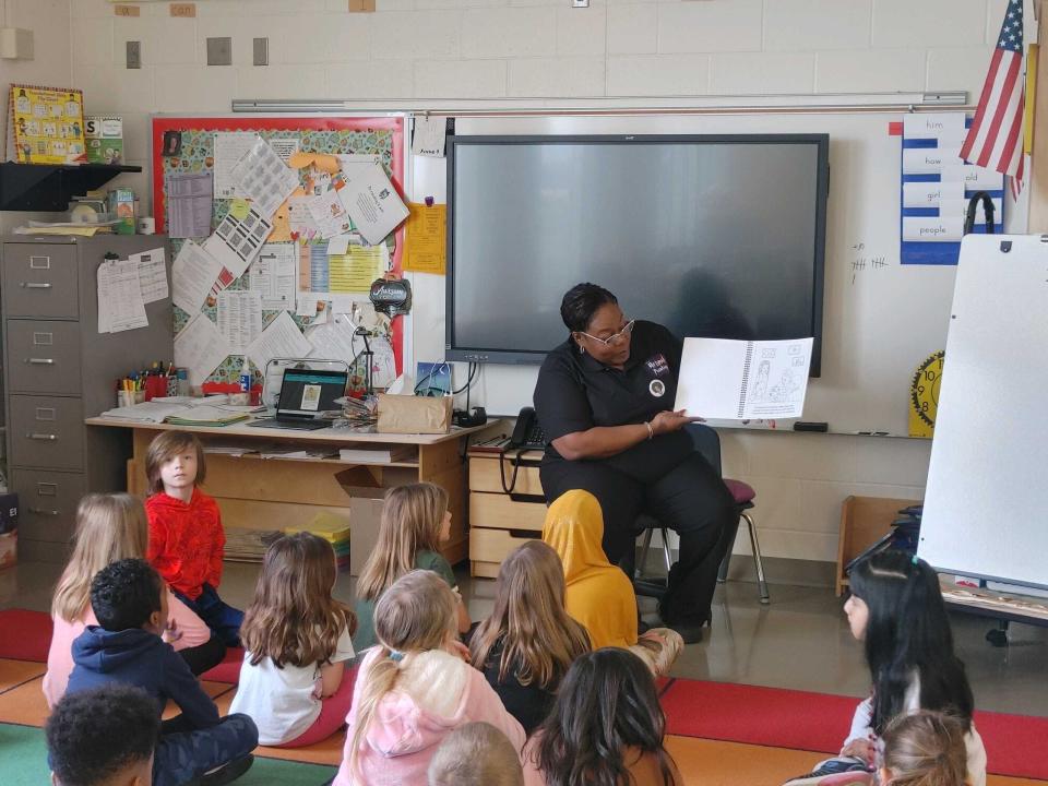 Antoinette Lee reading her children's painting book to a classroom in St. Cloud, Minnesota.