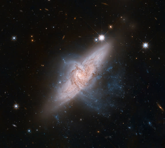 The NASA/ESA Hubble Space Telescope has produced an incredibly detailed image of a pair of overlapping galaxies called NGC 3314. The two galaxies look like they are colliding but it a trick of perspective. Released June 14, 2012.