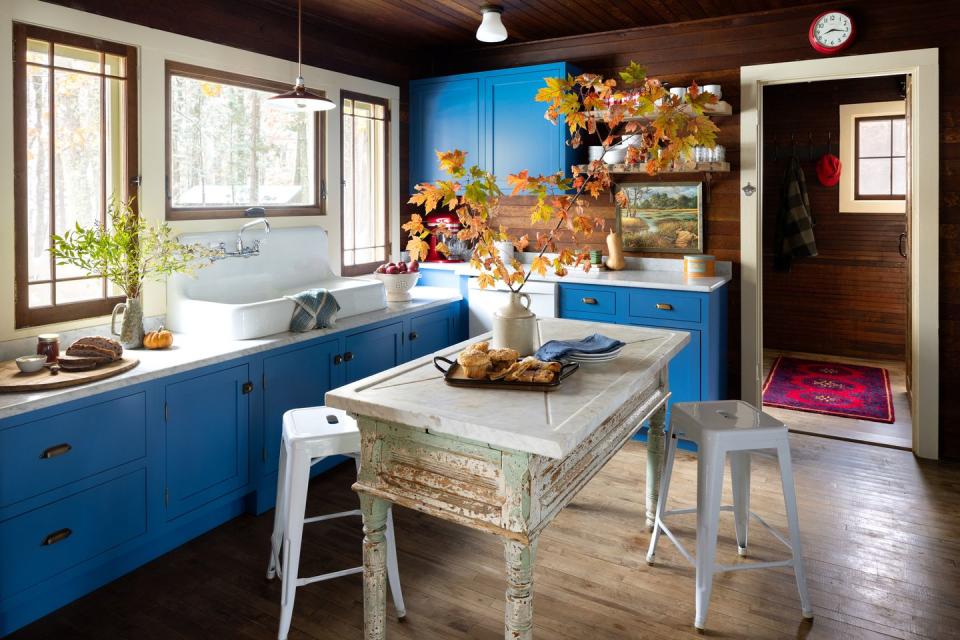 rustic cabin kitchen with bold blue cabinets