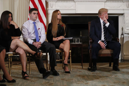 U.S. President Donald Trump hosts a listening session with Marjory Stoneman Douglas High School shooting survivors and students Jonathan Blank, his mother Melissa Blank (L) and Julia Cordover to discuss school safety at the White House in Washington, U.S., February 21, 2018. REUTERS/Jonathan Ernst