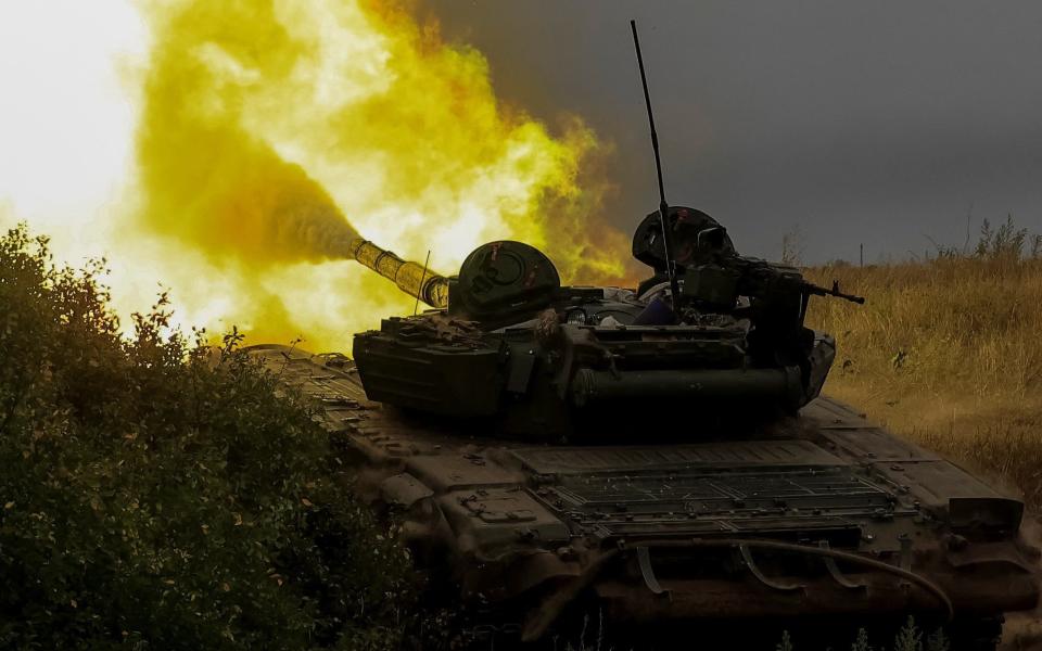 Ukrainian soldiers fire towards Russian troops from a tank at in the Donetsk region - REUTERS/Stringer