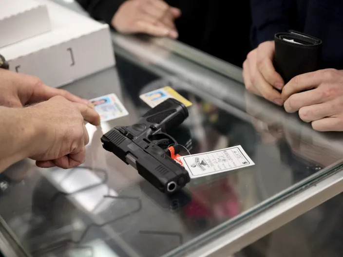 TINLEY PARK, ILLINOIS - APRIL 08: A customer purchases a gun at Freddie Bear Sports on April 08, 2021 in Tinley Park, Illinois. President Joe Biden today announced gun control measures which included stricter controls on the purchase of homemade firearms, commonly referred to as Ghost Guns and he made a push for national Red Flag legislation and other measures.