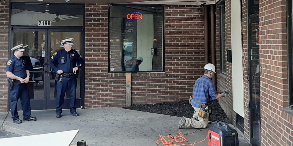 Queen City Lounge being boarded up.