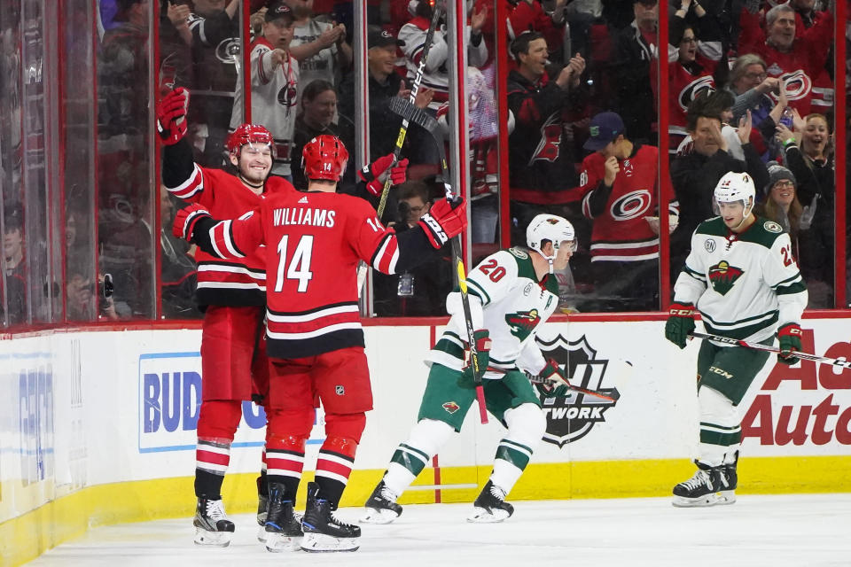 RALEIGH, NC - MARCH 23: Carolina Hurricanes Right Wing Justin Williams (14) congratulates Carolina Hurricanes Defenceman Brett Pesce (22) after scoring during a game between the Minnesota Wild and the Carolina Hurricanes at the PNC Arena in Raleigh, NC on March 23, 2019. (Photo by Greg Thompson/Icon Sportswire via Getty Images)