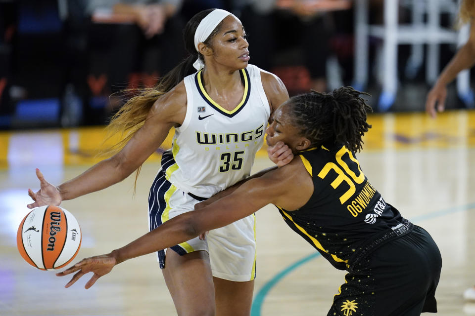 Los Angeles Sparks forward Nneka Ogwumike reaches for the ball controlled by Dallas Wings rookie forward Charli Collier during their game on May 14, 2021 in Los Angeles. (AP Photo/Ashley Landis)