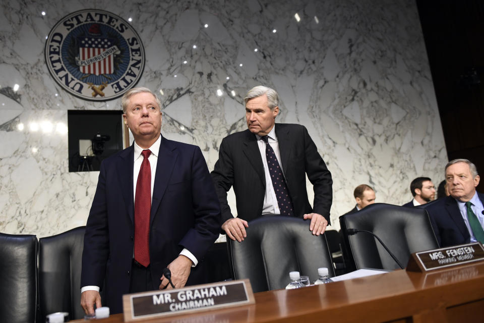 Senate Judiciary Committee Chairman Lindsey Graham, R-S.C., left, turns away after talking to Sen. Sheldon Whitehouse, D-R.I.,, center, during a break in a hearing with Department of Justice Inspector General Michael Horowitz on Capitol Hill in Washington, Wednesday, Dec. 11, 2019, to look at the Inspector General's report on alleged abuses of the Foreign Intelligence Surveillance Act. Sen. Dick Durbin, D-Ill., watches at right. (AP Photo/Susan Walsh)