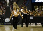 Texas cheerleaders perform during the first half of a third-round game between the Michigan and the Texas of the NCAA college basketball tournament Saturday, March 22, 2014, in Milwaukee. (AP Photo/Jeffrey Phelps)