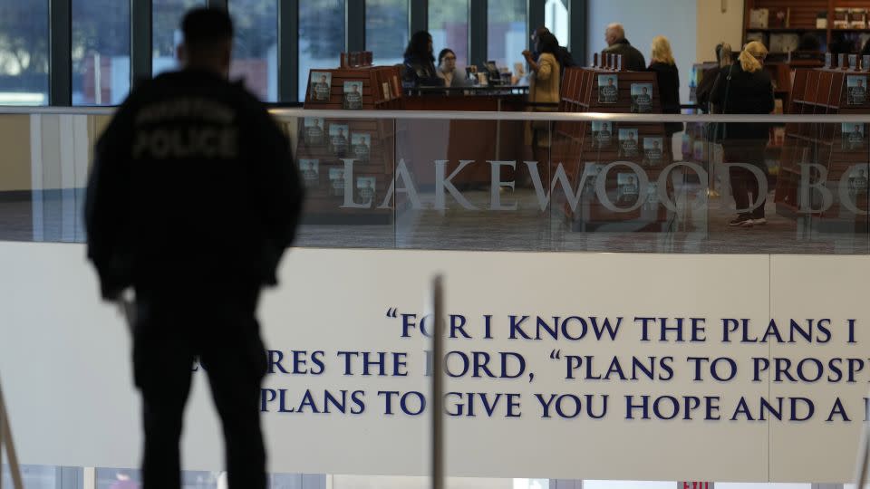 A police officer stands at the top of the steps inside Lakewood Church, Sunday, Feb. 18, 2024, in Houston. Pastor Joel Osteen welcomed worshippers back for the first time since a woman with an AR-style rifle opened fire in between services at his Texas megachurch last Sunday. - David J. Phillip/AP