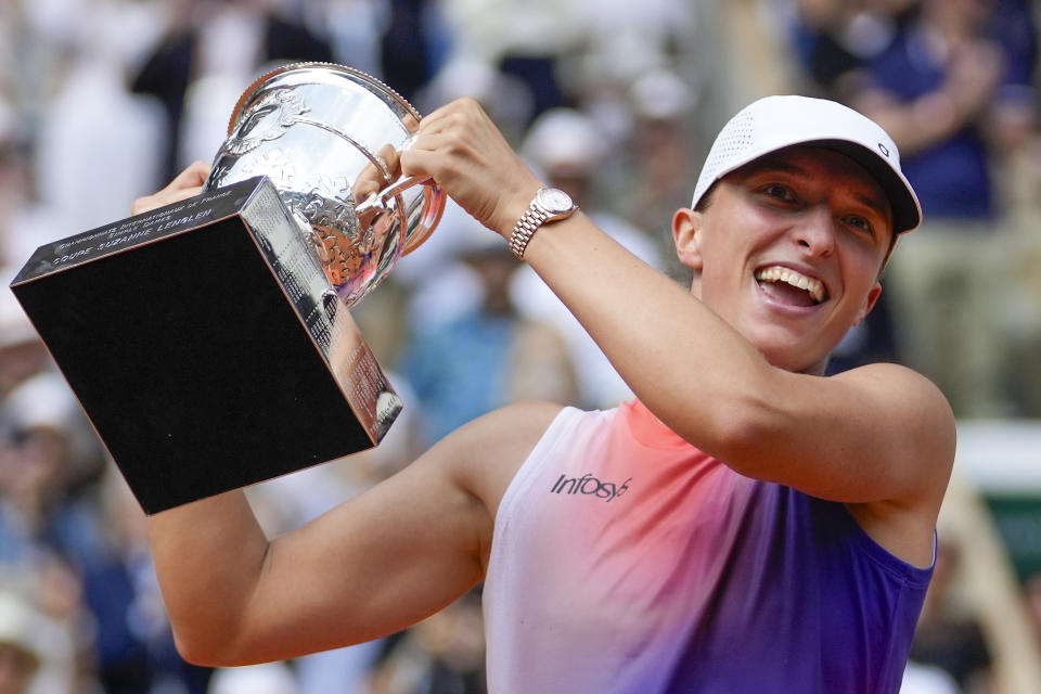 Poland's Iga Swiatek holds the trophy after winning the women's final of the French Open tennis tournament against Italy's Jasmine Paolini at the Roland Garros stadium in Paris, France, Saturday, June 8, 2024. (AP Photo/Thibault Camus)