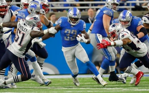 Detroit Lions running back Kerryon Johnson (33) breaks through the New England Patriots line during the second half of an NFL football game, Sunday, Sept. 23, 2018 - Credit: (AP Photo/Rick Osentoski)