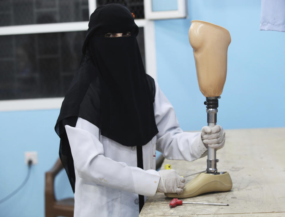 FILE - In this Feb. 1, 2018 file photo, Haida Ali al-Nasseri prepares a prosthetic leg at a hospital that receives funding from Saudi Arabia in Marib, Yemen. Land mines scattered by Yemen’s Houthi rebels will remain a threat even if the latest negotiations succeed in halting the civil war. While the Houthis’ firing of ballistic missiles deep into Saudi Arabia has drawn the most attention, their widespread use of mines within Yemen represents a risk for generations to come in the Arab world’s poorest country. Yemen is also littered with unexploded cluster munitions and bombs dropped by the Saudi-led coalition, including some made in the United States. (AP Photo/Jon Gambrell, File)