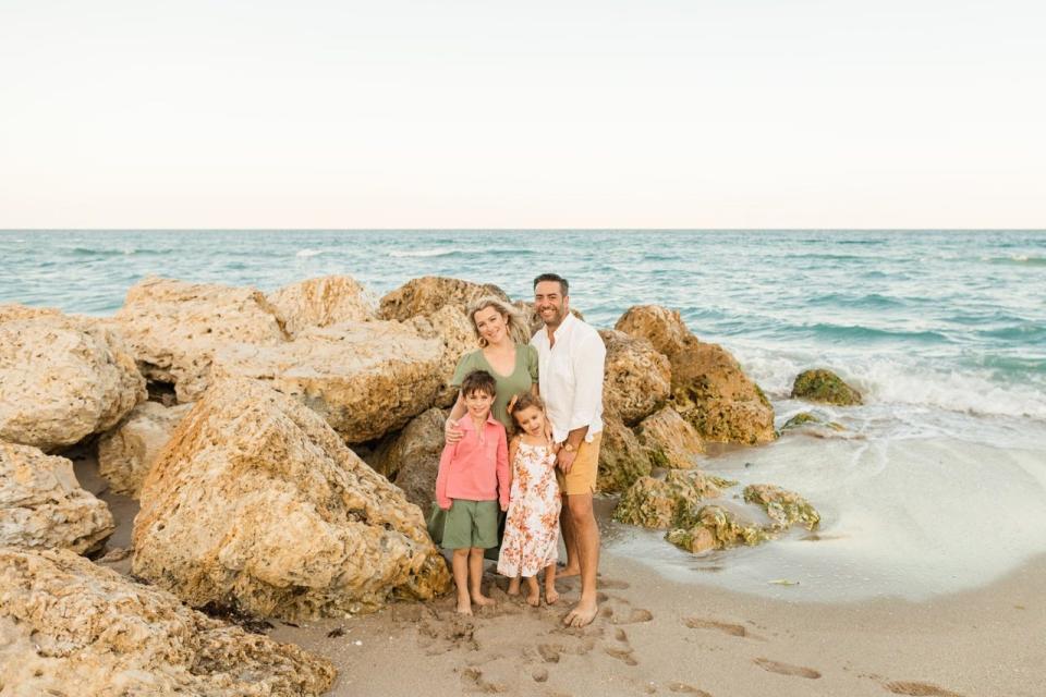 George family posing for a photo by the ocean