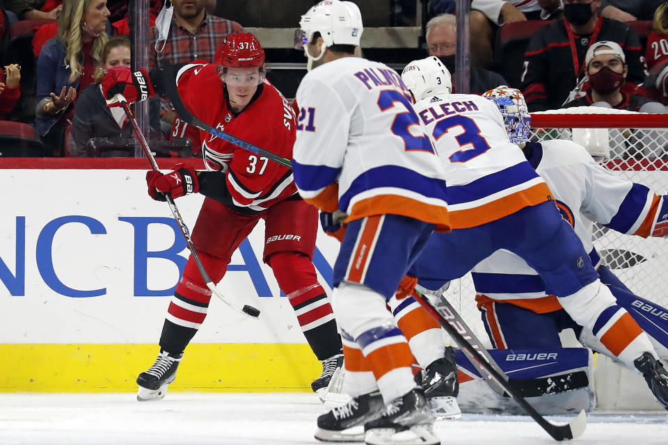 Carolina Hurricanes' Andrei Svechnikov (37) attempts to shoot past New York Islanders' Kyle Palmieri (21), Adam Pelech (3) and goaltender Ilya Sorokin during the third period of an NHL hockey game in Raleigh, N.C., Thursday, Oct. 14, 2021. (AP Photo/Karl B DeBlaker)