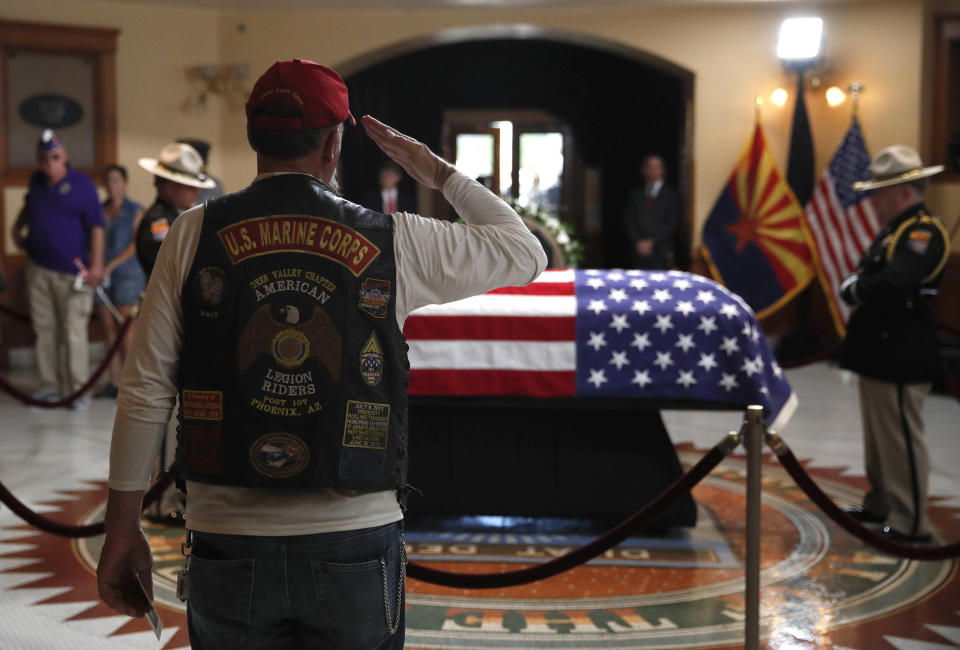 A former U.S. Marine salutes near the casket during a memorial service for Sen. John McCain, R-Ariz. at the Arizona Capitol on Wednesday, Aug. 29, 2018, in Phoenix. (AP Photo/Jae C. Hong, Pool)