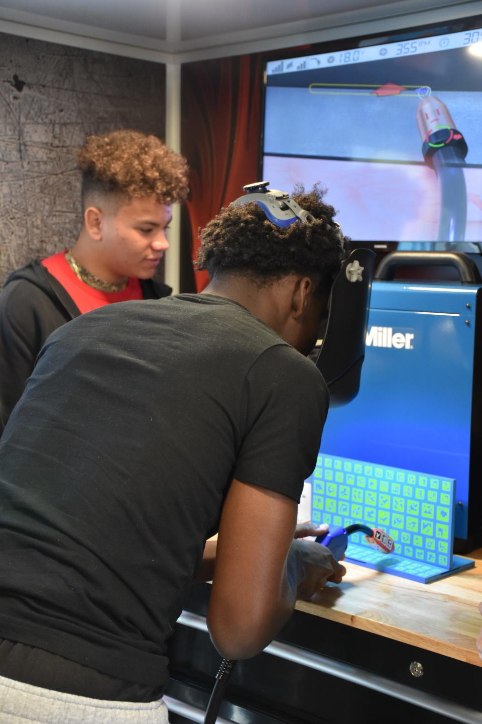 Students onboard the mobile workshop often compete for the highest score on the virtual reality trades simulators.