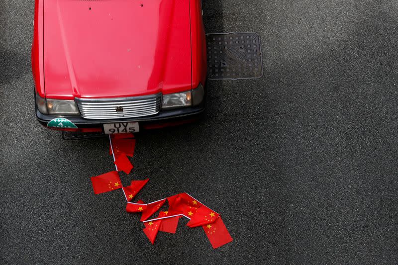 Chinese national flags are seen on the ground during a march against national security law at the anniversary of Hong Kong's handover to China from Britain, in Hong Kong