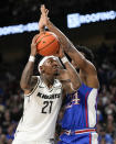 Central Florida forward C.J. Walker (21) goers up for a shot against Kansas forward K.J. Adams Jr. (24) during the first half of an NCAA college basketball game, Wednesday, Jan. 10, 2024, in Orlando, Fla. (AP Photo/John Raoux)