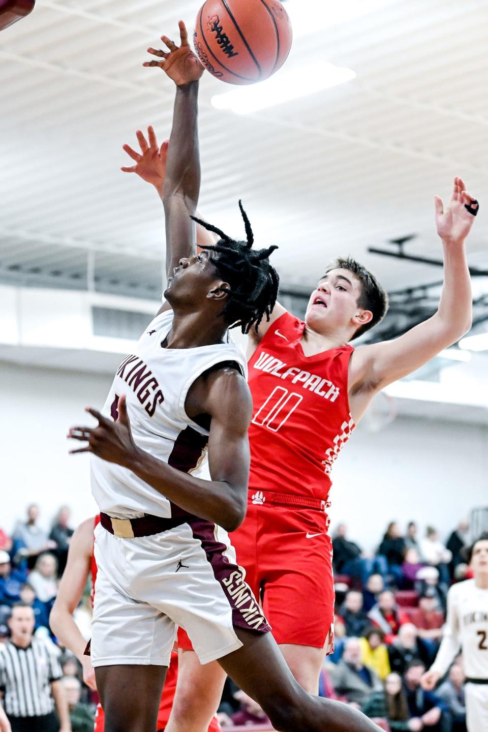 Laingsburg's Jackson Audretsch, right, and Potterville's Da'Marion Hicks go for a rebound during the third quarter on Friday, Jan. 20, 2023, at Potterville High School.