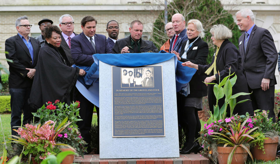 Florida Governor Ron DeSantis, center left; Lake County Sheriff Peyton C. Grinnell, center; State representative Geraldine Thompson, 2nd from left, and other elected officials and family members unveil the Groveland Four monument in front of the Old Lake County courthouse in Tavares, Fla., Friday, February 21, 2020. The monument honors the four men who were falsely accused of rape in 1949. (Joe Burbank/Orlando Sentinel/Tribune News Service via Getty Images)
