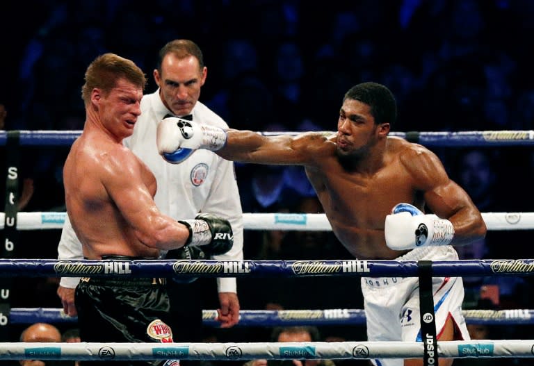 Anthony Joshua sends Aleander Povetkin tumbling to the canvas in the seventh round of their heavyweight world title fight at Wembley