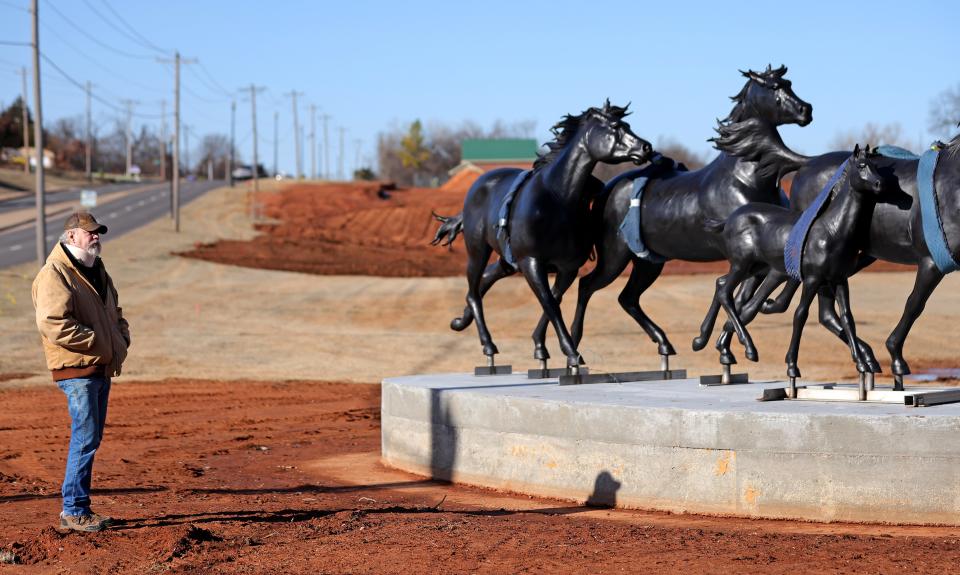 Artist Paul Moore watches Jan. 11 as his sculpture, titled "Valle del Caballo," is installed at the corner of E Second Street and Coltrane Road in Edmond.