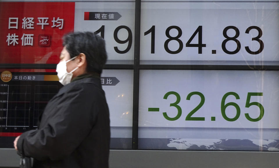 A man walks past an electronic stock board showing Japan's Nikkei 225 index at a securities firm in Tokyo, Thursday, March 30, 2017. Asian stocks are drifting lower on Thursday after a lackluster performance on Wall Street. (AP Photo/Eugene Hoshiko)