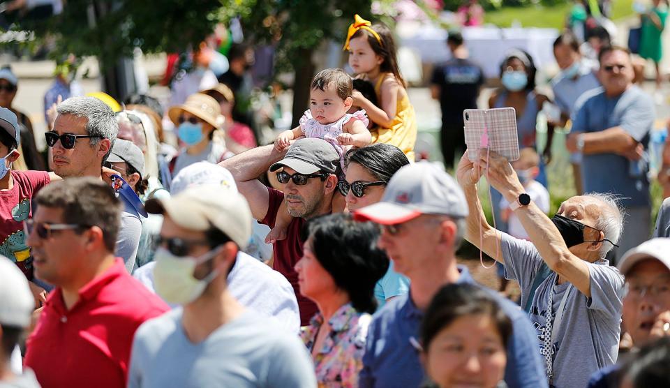 Spectators watch the traditional lion and dragon dances at the August Moon Festival in Quincy on Sunday, Aug. 15, 2021.