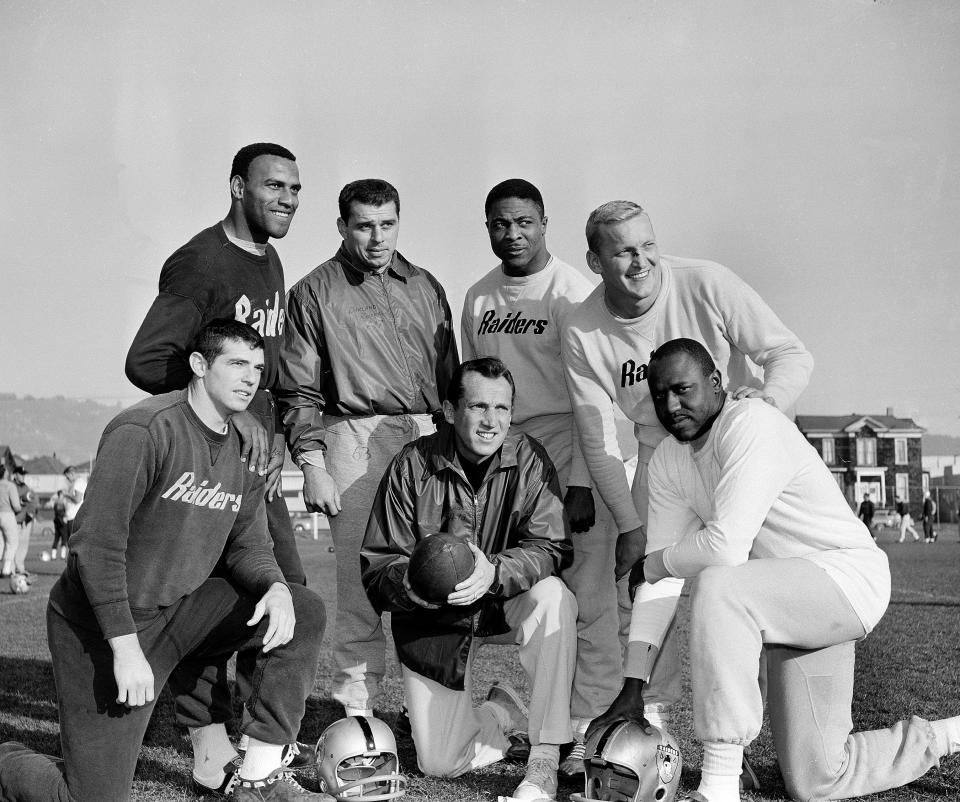 Raiders coach and GM Al Davis poses with six of his players who were named to the AP AFL All-Star Team, from left, defensive backs Tommy Morrow and Fred Williamson, linebacker Archie Matsos, halfback Clem Daniels, center Jim Otto and end Art Powell, Dec. 17, 1963.