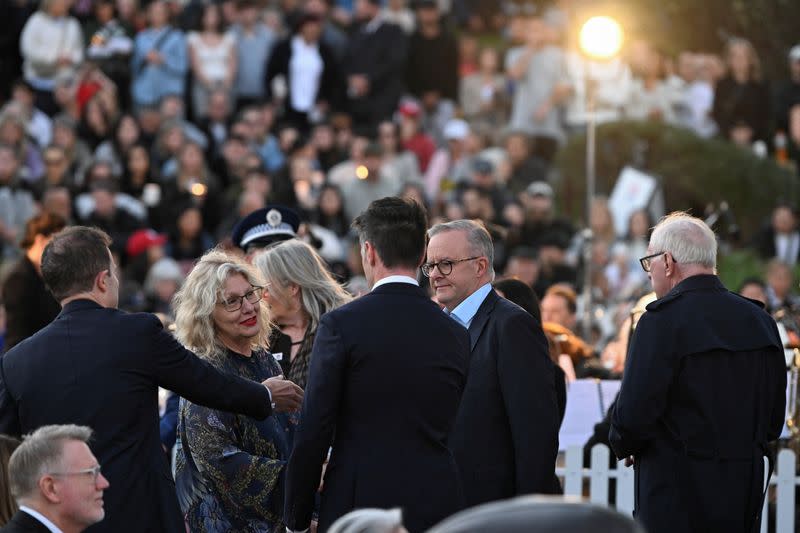 People gather for a candlelight vigil on Bondi Beach to pay respects to the victims of a fatal stabbing attack at a shopping centre in Sydney