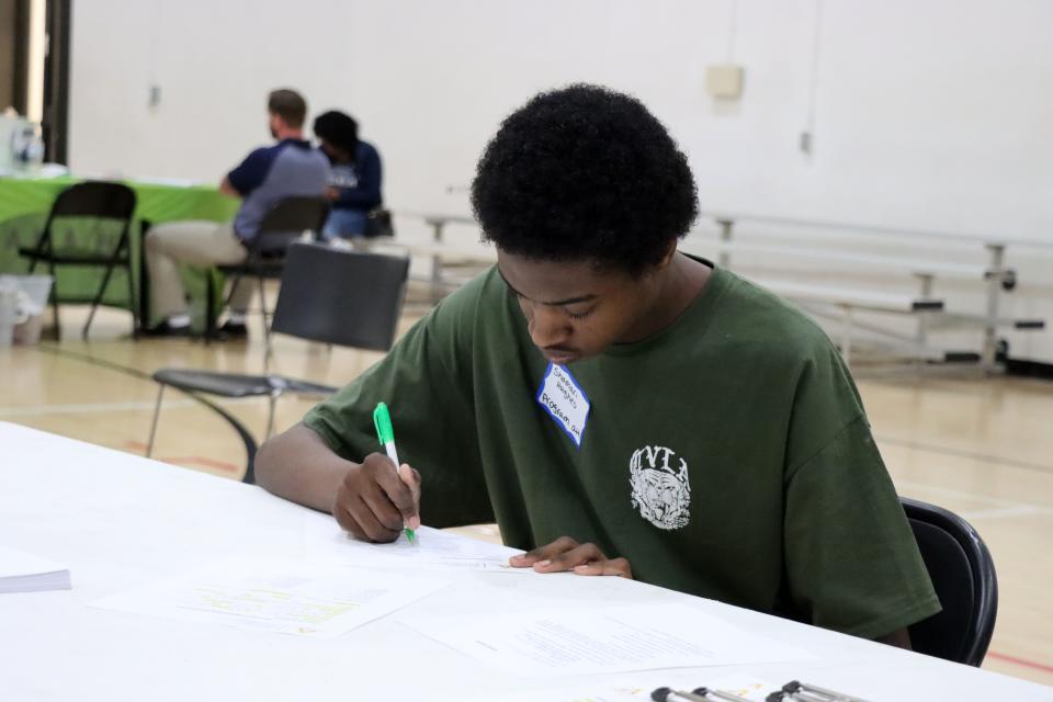 Shamari Hughes fills out the application for a Program Assistant at the Amarillo Parks and Recreation Department Job Fair at the Charles E. Warford Activity Center in this file photo.