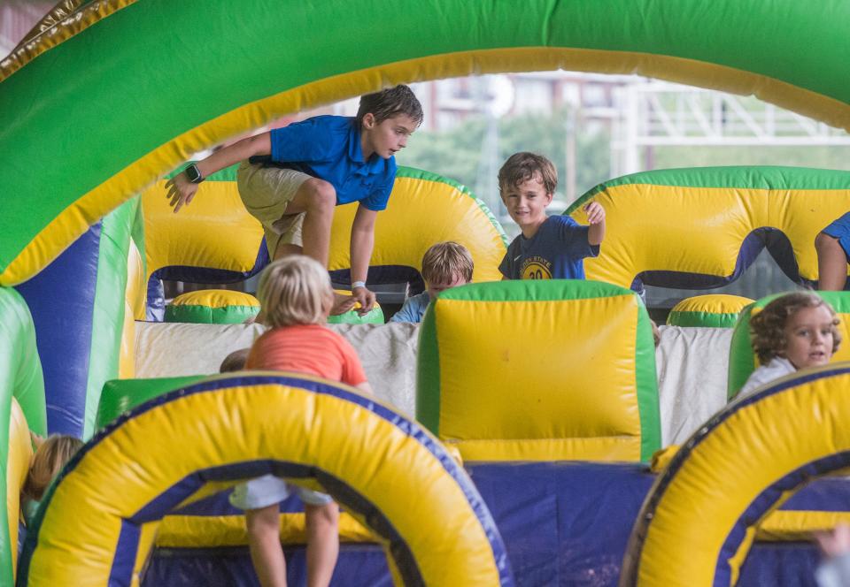 Kids have fun playing on the inflatables at Hog Days of Summer.