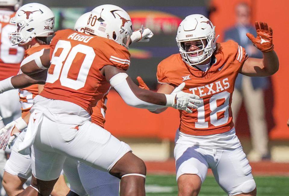 Texas linebacker Liona Lefau, right, celebrates a defensive stop against Kansas State last season. Texas head coach Steve Sarkisian praised the sophomore on Monday, saying he's one of the best teammates on the squad and could player a bigger role in 2024.