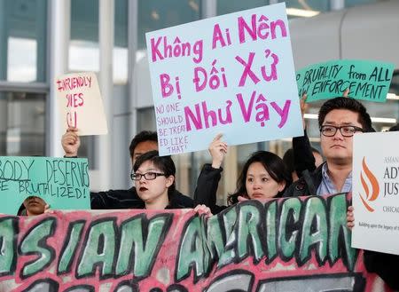 Community members protest the treatment of Dr. David Dao, who was forcibly removed from a United Airlines flight on Sunday by the Chicago Aviation Police, at O'Hare International Airport in Chicago, Illinois, U.S., April 11, 2017. REUTERS/Kamil Krzaczynski