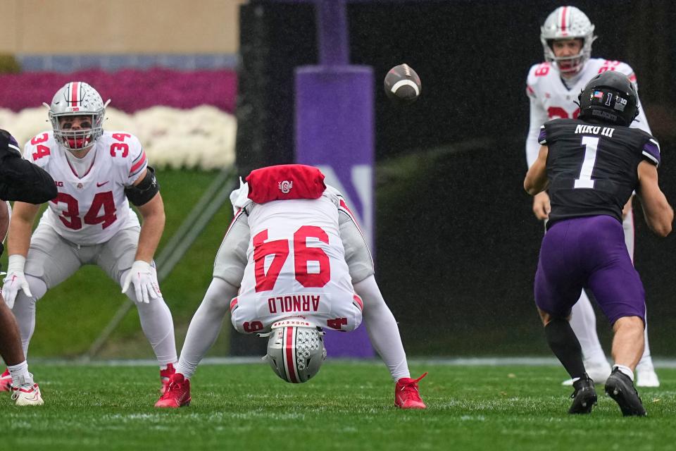 Nov 5, 2022; Evanston, Illinois, USA; Ohio State Buckeyes long snapper Mason Arnold (94) snaps the ball to punter Jesse Mirco (29) during the first half of the NCAA football game against the Northwestern Wildcats at Ryan Field. Mandatory Credit: Adam Cairns-The Columbus Dispatch