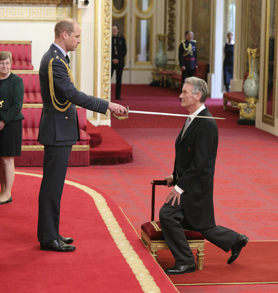 Michael Palin is made a Knight Commander of the Order of St Michael and St George by Prince William during an investiture ceremony at Buckingham Palace, London, Wednesday June 12, 2019. (Yui Mok/PA via AP)